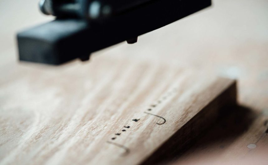 Holzbrett wird von Maschine bedruckt mit 