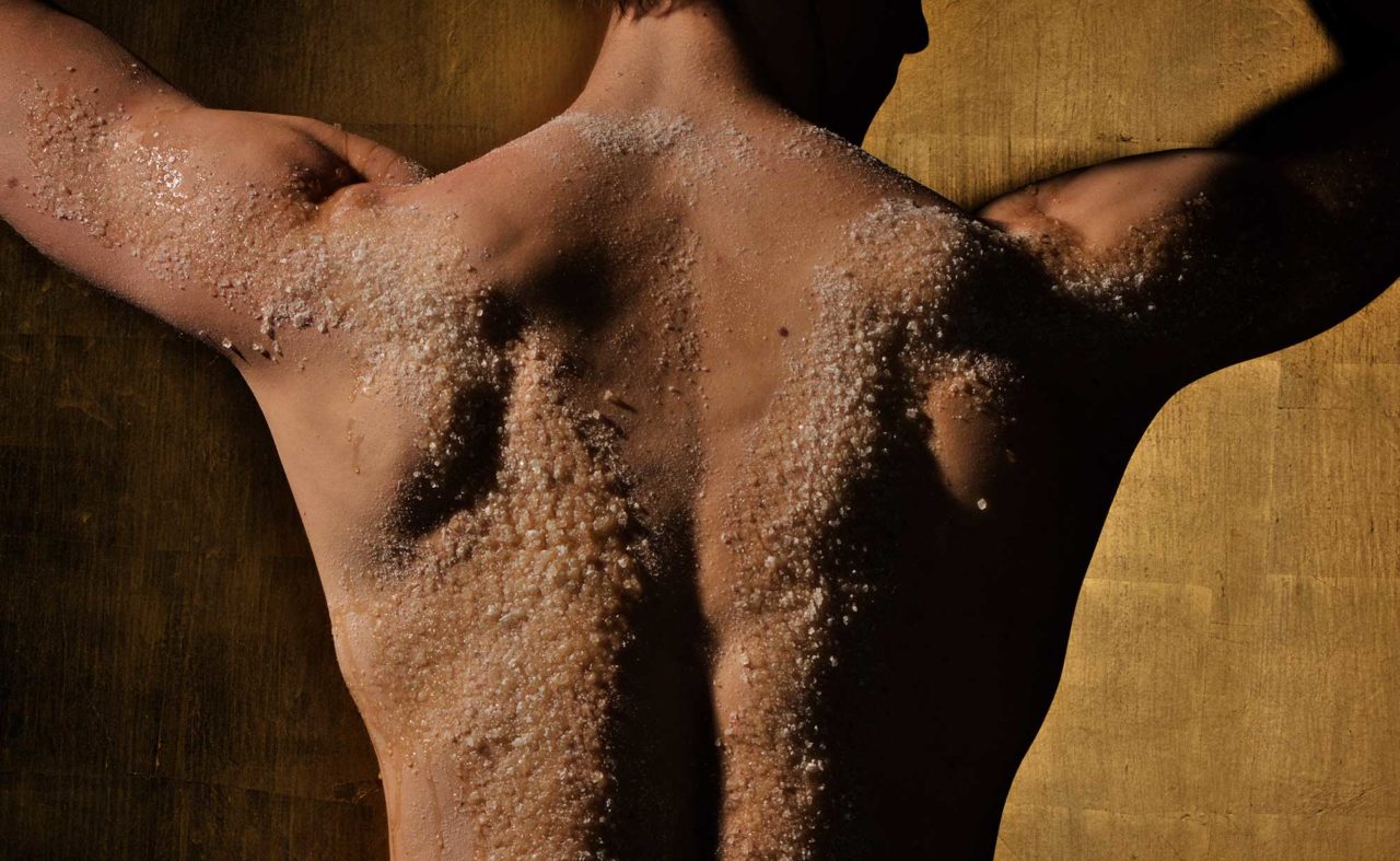 Rücken eines Mannes mit wohltuenden Peeling auf der Haut im Hotel Neuruppin